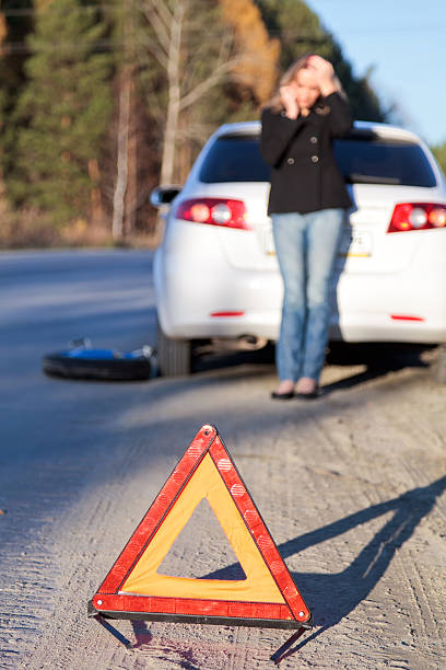 istock Traffic hazard triangle with young woman and white car 108720722