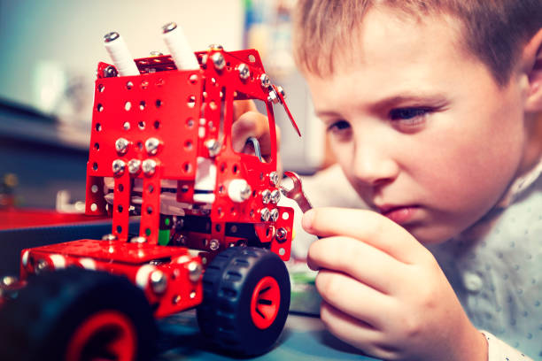 istock Boy turns a toy car 1087207828
