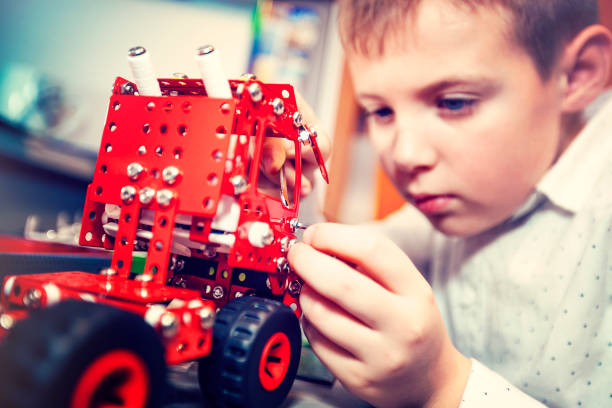 istock Boy turns a toy car 1087207830