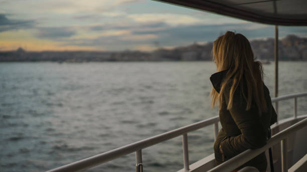 istock Girl watching the sea from the ship 1087209488