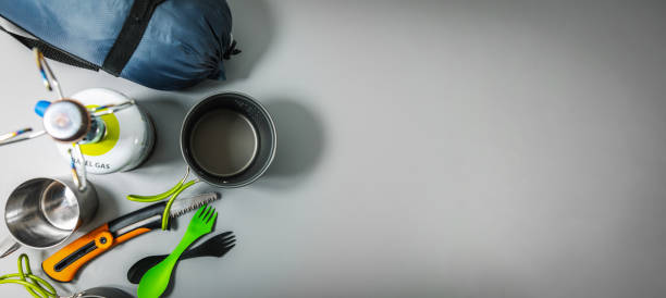 expedition camping equipment on gray background with copy space
