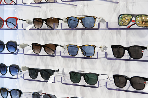 Sunglasses for sale, placed on the shelves, horizontal formation