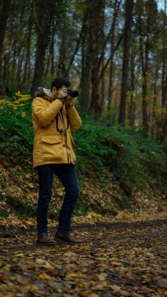 istock Man taking pictures in the forest 1087214830