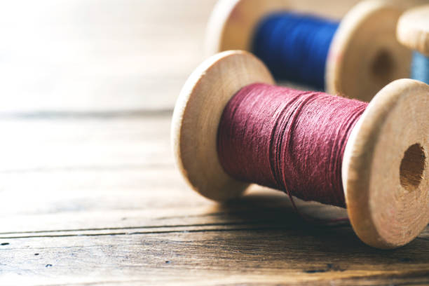 istock Wooden spools of thread close-up. Selective focus. Rendered image. Copy space 1087217114