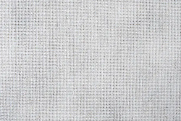Photo of Fabric canvas for cross stitch crafts. Texture of cotton fabric.