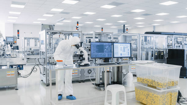 istock Shot of Sterile Pharmaceutical Manufacturing Laboratory where Scientists in Protective Coverall's Do Research, Quality Control and Work on the Discovery of new Medicine. 1087218942