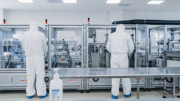 istock Manufacturing Laboratory where Scientists in Protective Coverall's Work with Industrial High Precision 3D Printing Machinery. Manufacturing Pharmaceutical / Technological / Industrial Products. 1087219006