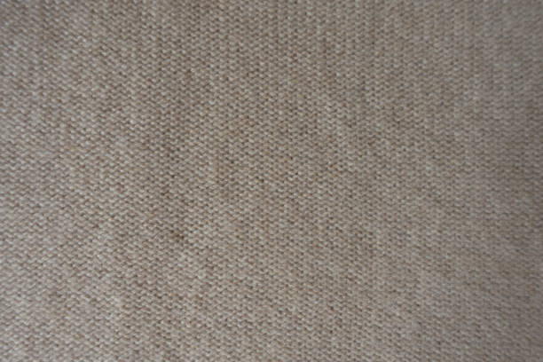 istock Top view of wrong side of beige knitted fabric 1087224172