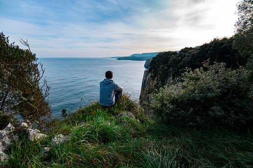 Man admiring the view,lighthouse, Neist Point, Isle of Skye, Highland Region, Scotland, United Kingdom