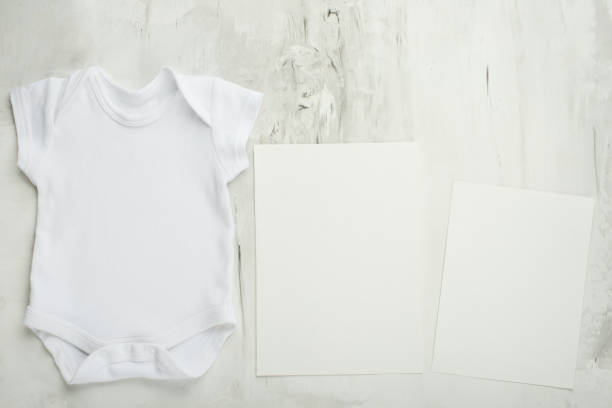 istock Layout Flat Put on a two white baby body shirt, on a white background. Layout for design and placement of logos, advertising 1087225994