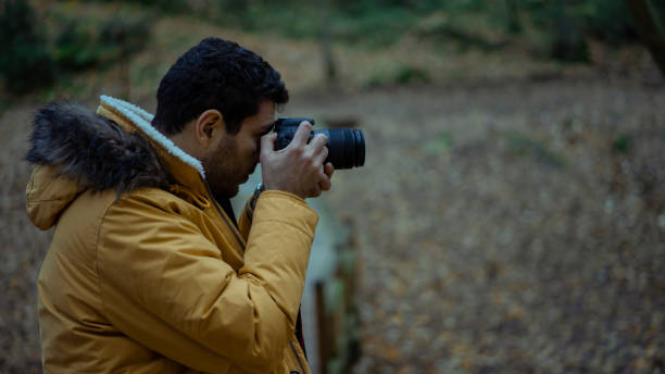 istock Man taking pictures in the forest 1087227368