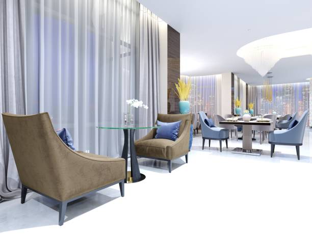 istock A table with two easy chairs in the contemporary lounge restaurant. Lighted comfortable space with large windows with evening lighting. 1087229802