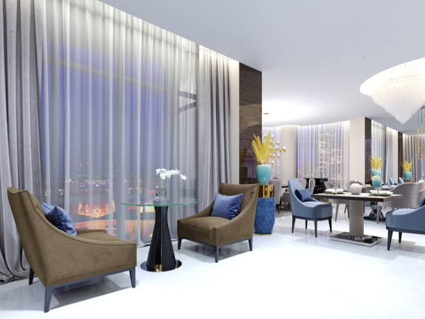 istock A table with two easy chairs in the contemporary lounge restaurant. Lighted comfortable space with large windows with evening lighting. 1087231620