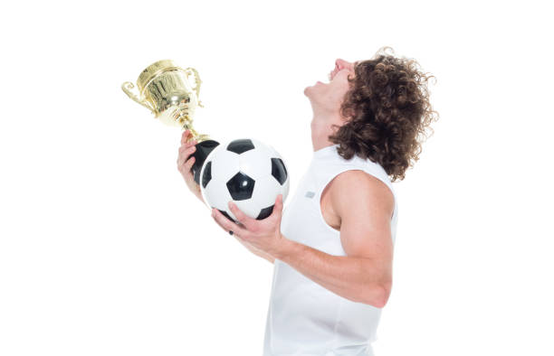 istock Man holding a trophy and soccerball 1087232264