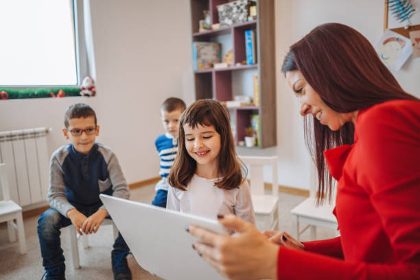 istock female teacher teaching  kids in classroom 1087233594