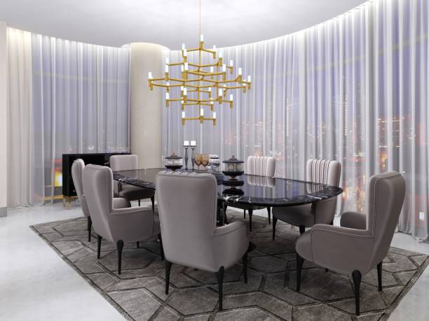 istock Large dining table in the hotel for eight people with a black table with a glass tabletop. Large and soft comfortable chairs and a golden chandelier near a large panoramic window. 1087234170