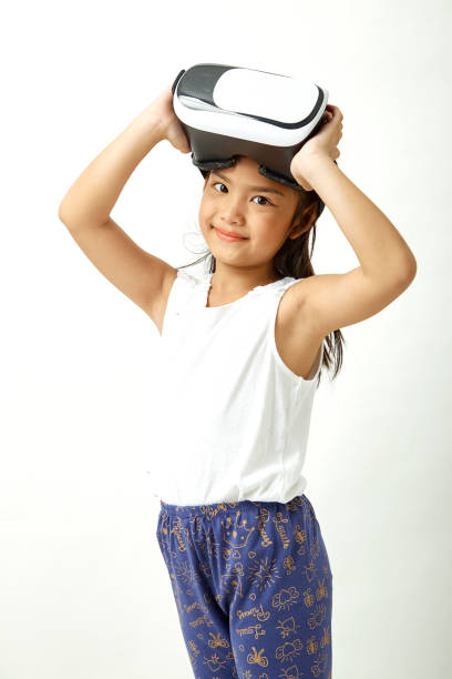 istock Cute girl having fun with virtual reality headset. Innovation technology and education concept 1087236420