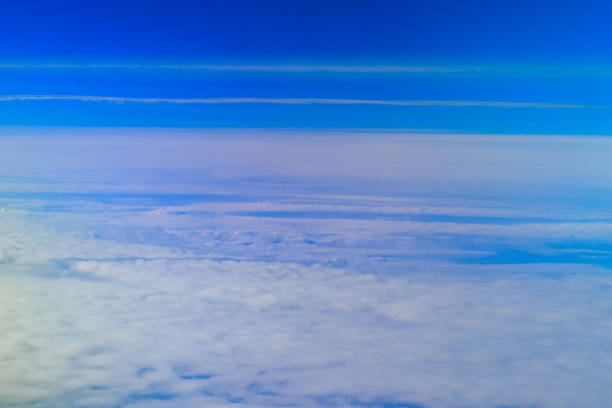 istock Beautiful white clouds in blue sky. View from airplane 1087238426