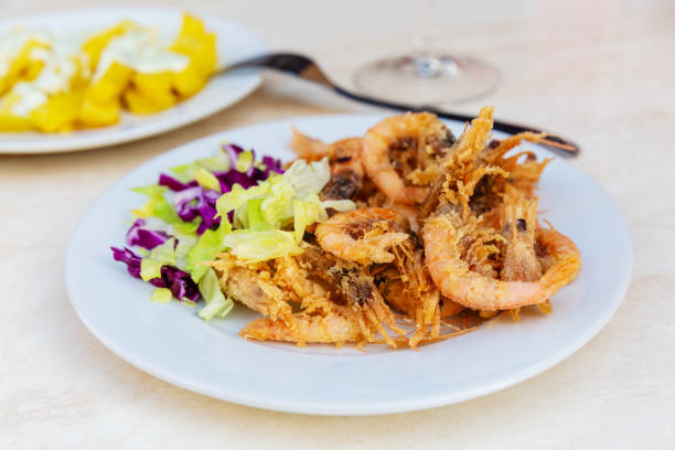 istock Spanish tapas, fried shrimps, fried potato chips and aioli 1087248870