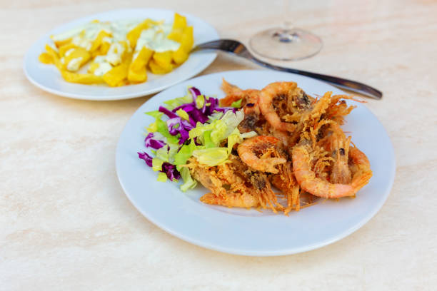 istock Spanish tapas, fried shrimps, fried potato chips and aioli 1087248892