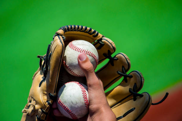 istock baseball player holding balls in hand and mitt to pitch 1087249736