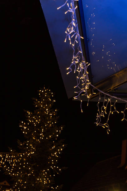 istock christmas tree and lights at night shopping mall 1087249900