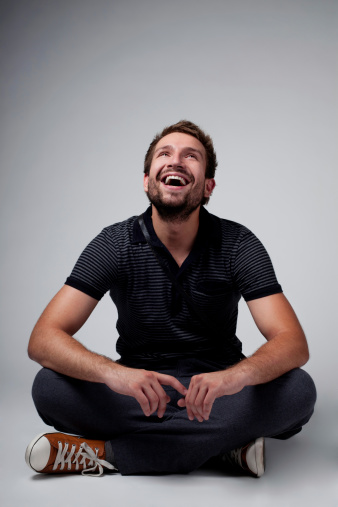 Portrait of handsome man sitting with crossed legs