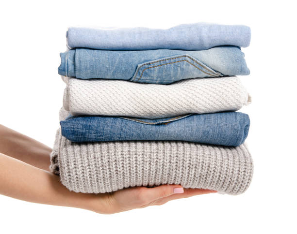 istock Stack of clothing jeans sweaters in hand 1087254020