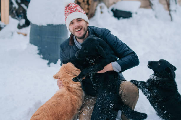 istock Man enjoying with golden retriever at winter 1087254068
