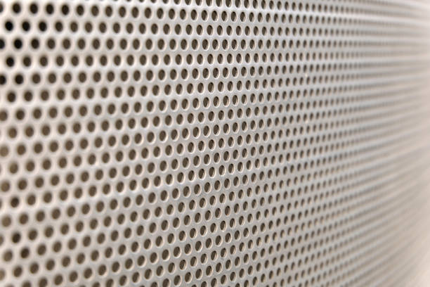 istock grey steel surface with little round holes 1087255956