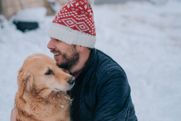 istock Man enjoying with golden retriever at winter 1087256442