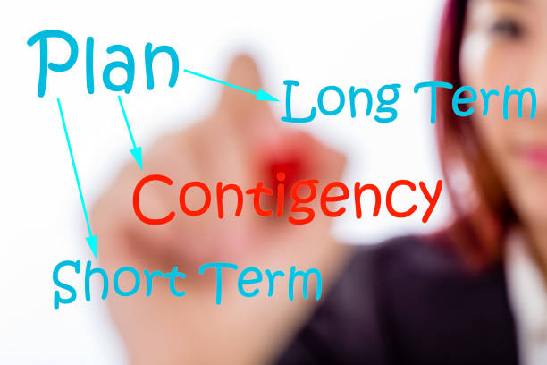 istock Asian businesswoman writing contigency plan 1087261040