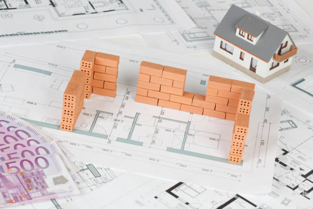istock Model house construction with brick on blueprint 1087264760