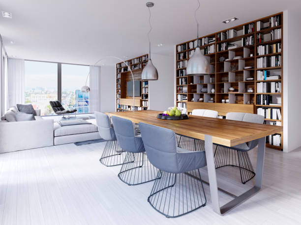 istock dining area with a modern designer table with six chairs in a loft style. Large built-in shelves for books, kitchen and living area. 1087265414
