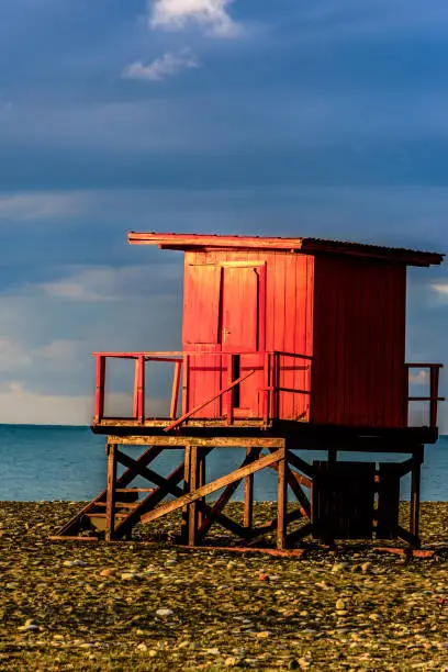 Photo of The sunrises lighting the small wooden house on the beach in Bat