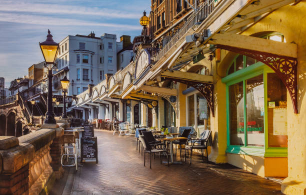 The low afternoon sun illuminates the cafes and restaurants along the West Cliff arcade on a quiet but sunny Christmas Eve. Ramsgate, UK - Dec 24 2018. The low afternoon sun illuminates the cafes and restaurants along the West Cliff arcade which overlooks the Royal Harbour and sea on a quiet but sunny Christmas Eve. thanet photos stock pictures, royalty-free photos & images