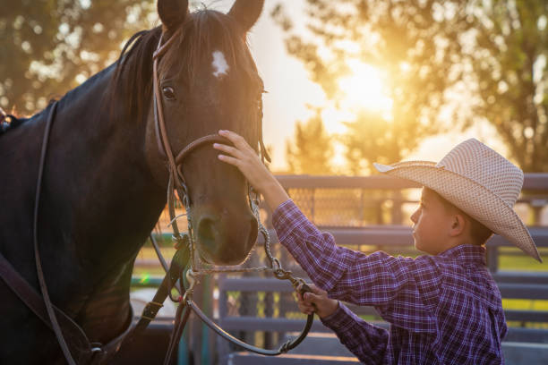istock Young cowboy together with his horse 1087281180