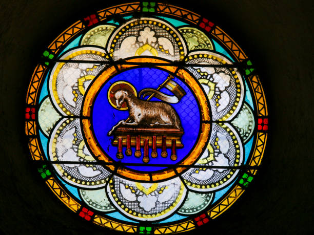 Agnus Dei or Lamb of God - Stained Glass in Antibes Church Stained Glass in the Church of Antibes, France, depicting the Agnus Dei or the Lamb of God agnus dei stock pictures, royalty-free photos & images