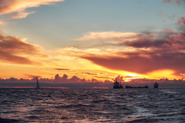istock Sea sunset with ships and boat on horizon 1087281572