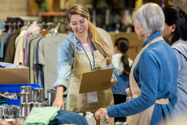 istock Women sort through donations during clothing drive 1087283500