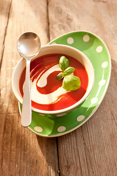 Tomato soup with Creme Fraiche and basil / Tomatensuppe stock photo