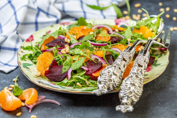 istock Organic arugula salad, tangerine and baked beetroot. 1087290242