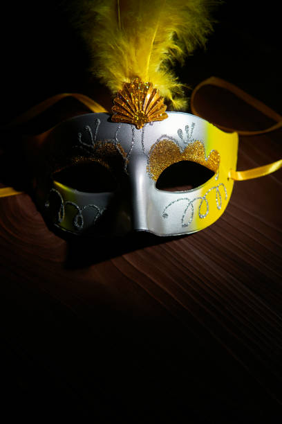 istock Colorful festive mask on wood in dark 1087291934