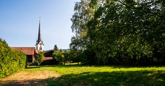 Detail of among the wooden village houses is a church tower in in Germany.