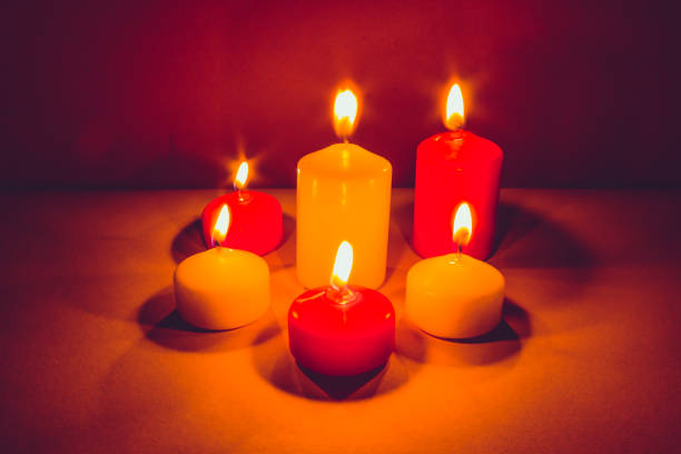 istock Multicolored candles burning in the dark 1087297066