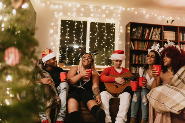 istock Generation Z Friends Christmas Party Singing With Guitar 1087299320