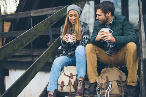 istock Happy couple drinking hot tea outdoor on cozy camping 1087301694