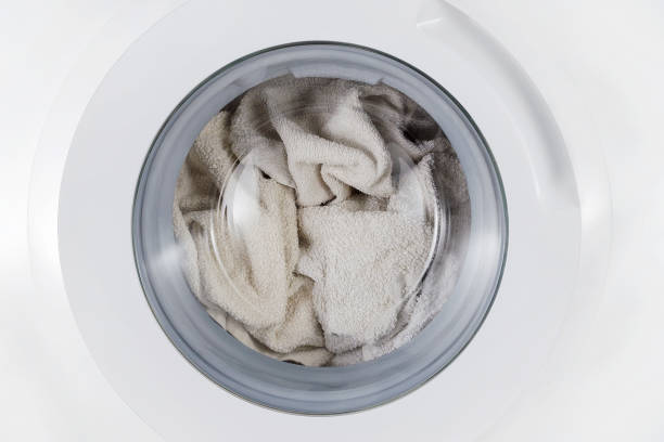istock white clothes wash, closed washing machine with towel closeup 1087302812