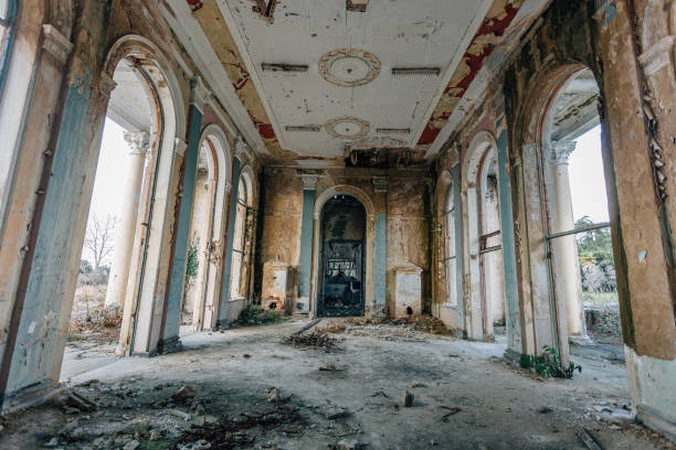 istock Ruined large hall interior overgrown by plants and moss 1087311858