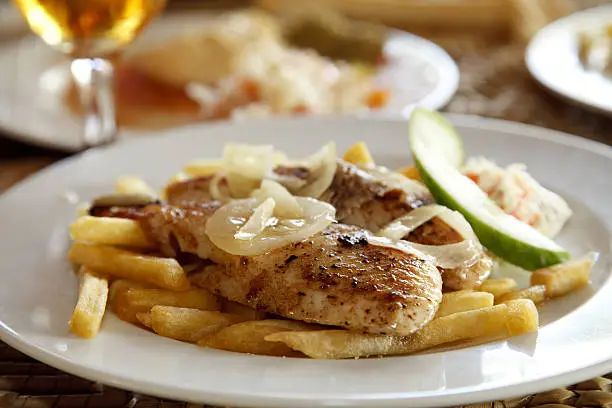 grilled fish and chips on a plate, shallow DOF